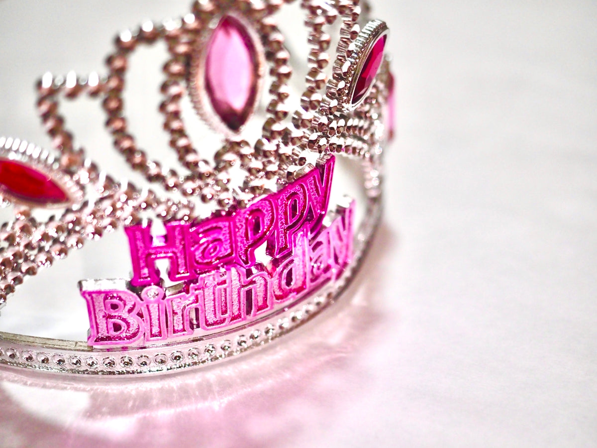 gold and purple crown on white textile