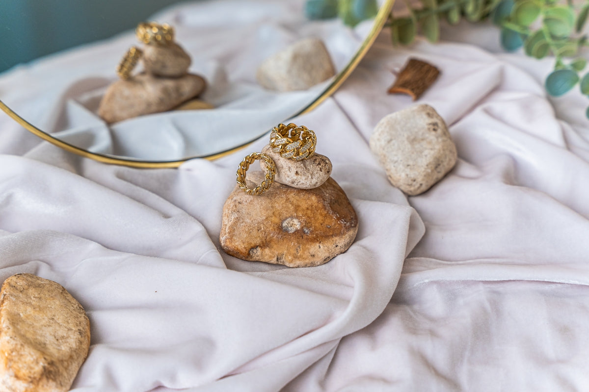 a mirror and some rocks on a table