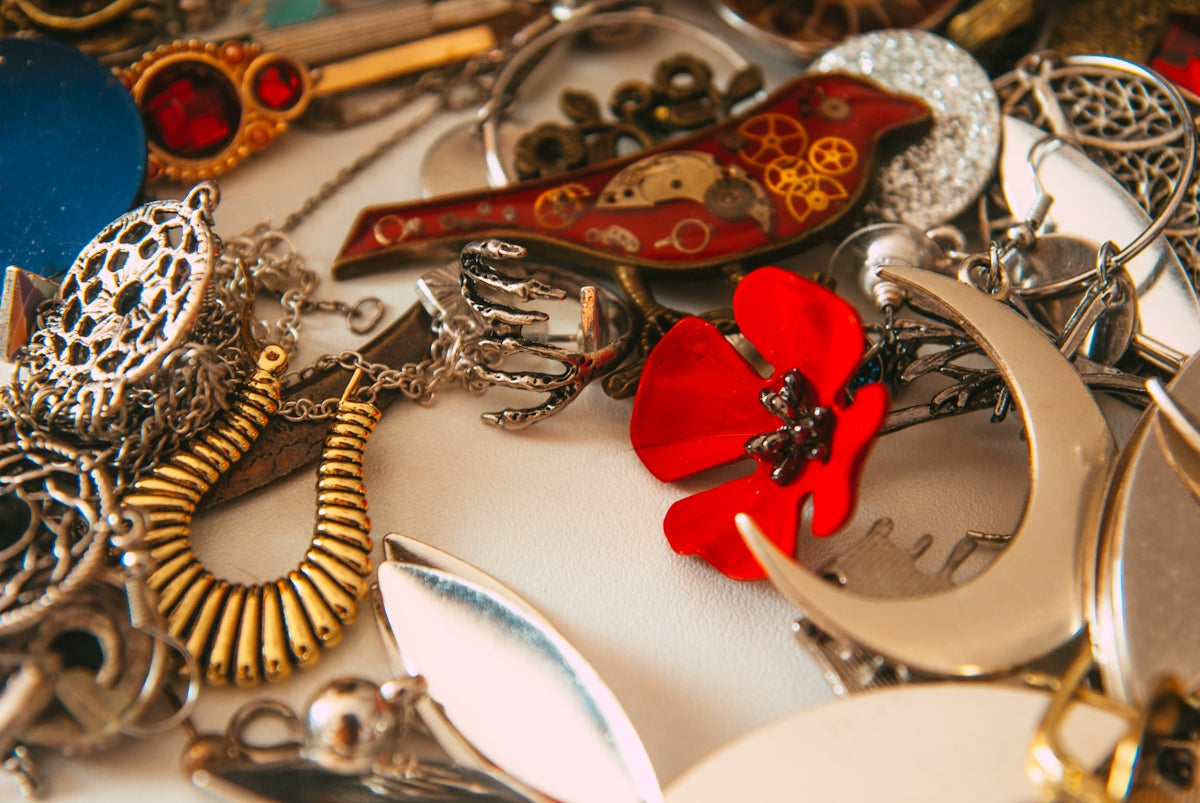 a table topped with lots of different types of jewelry