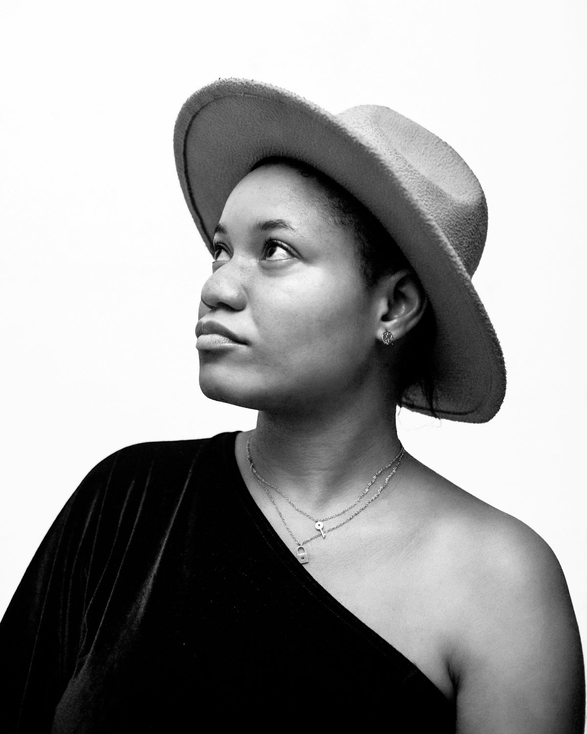 A black and white photo of a woman wearing a hat