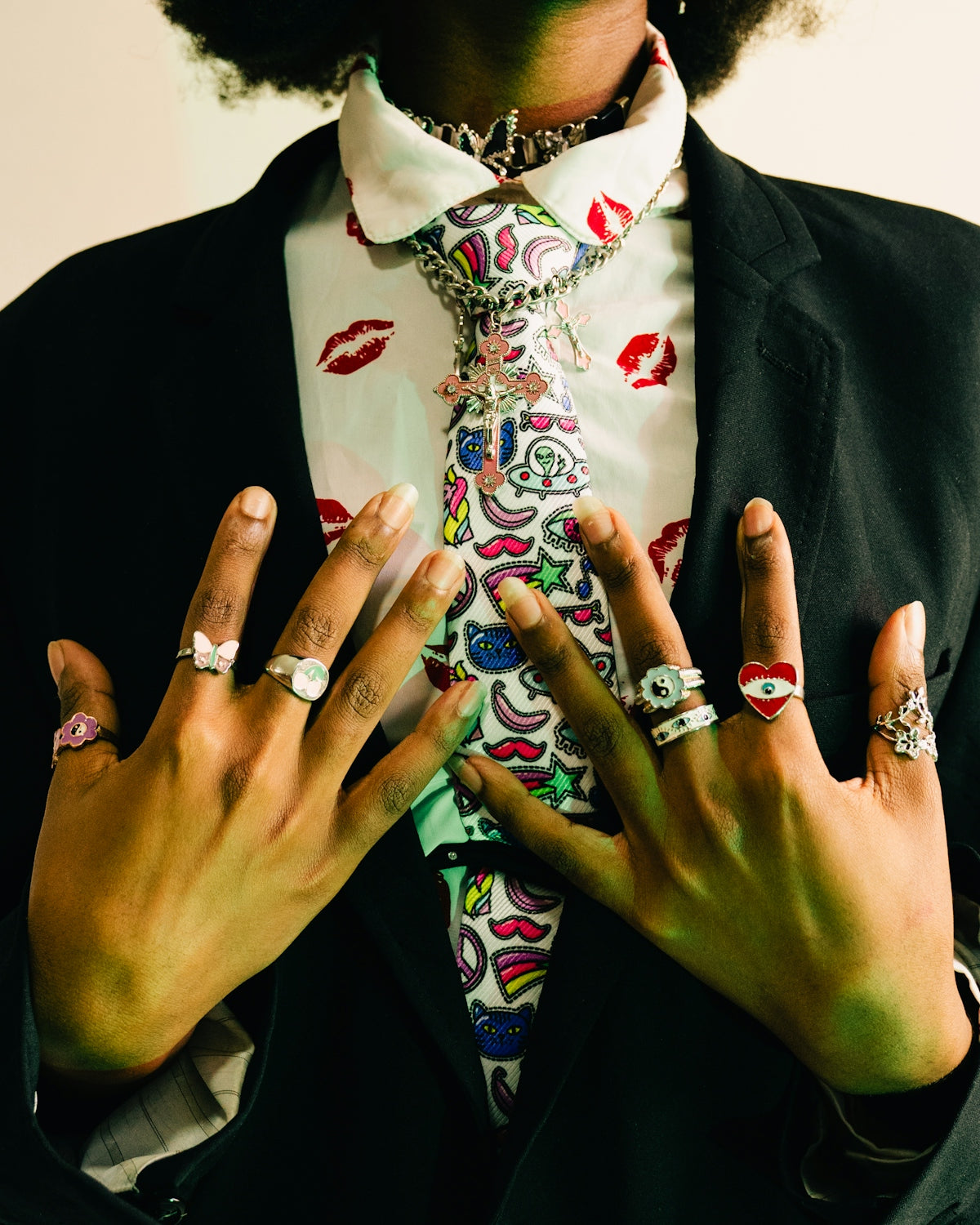 Person wearing a suit with a colorful tie and rings.