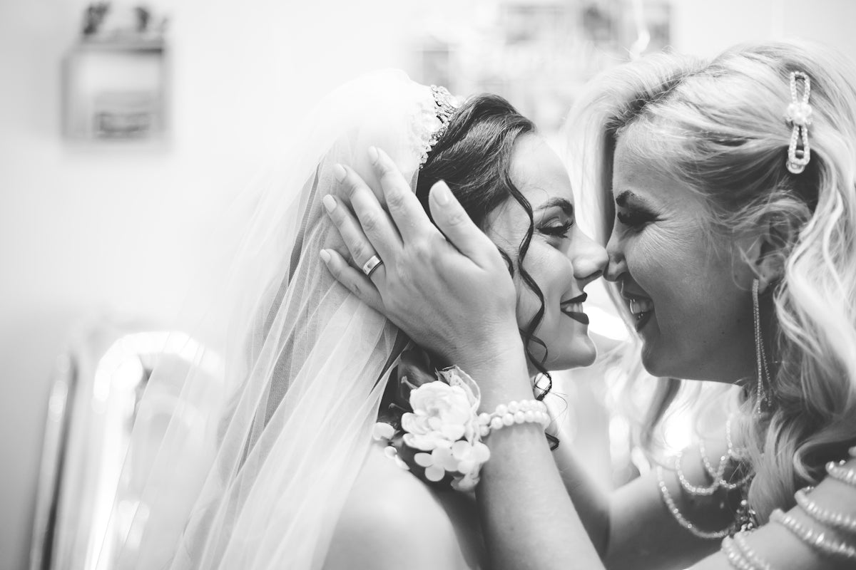 Bride and mother share a tender moment