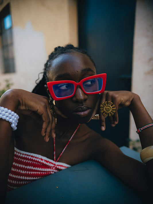 Woman with red glasses and jewelry