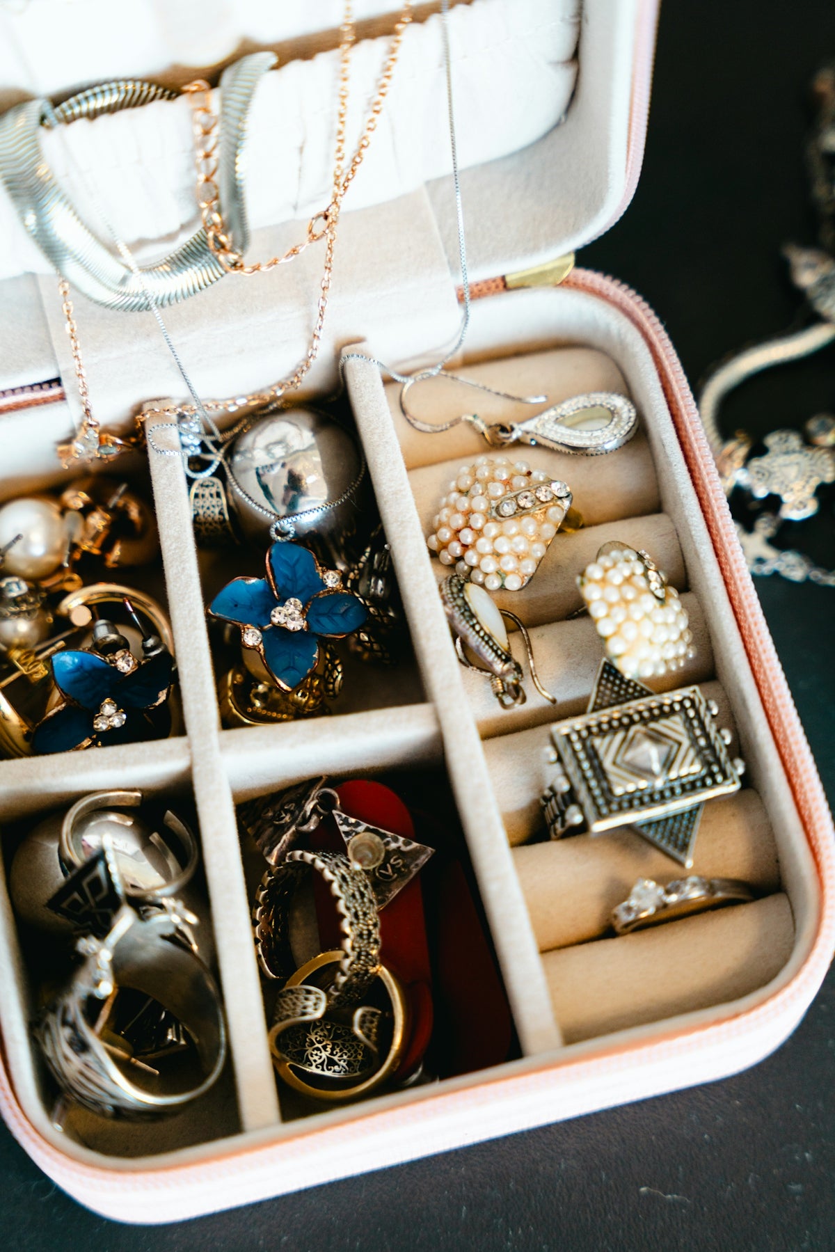 Jewelry box filled with necklaces, rings, and earrings.
